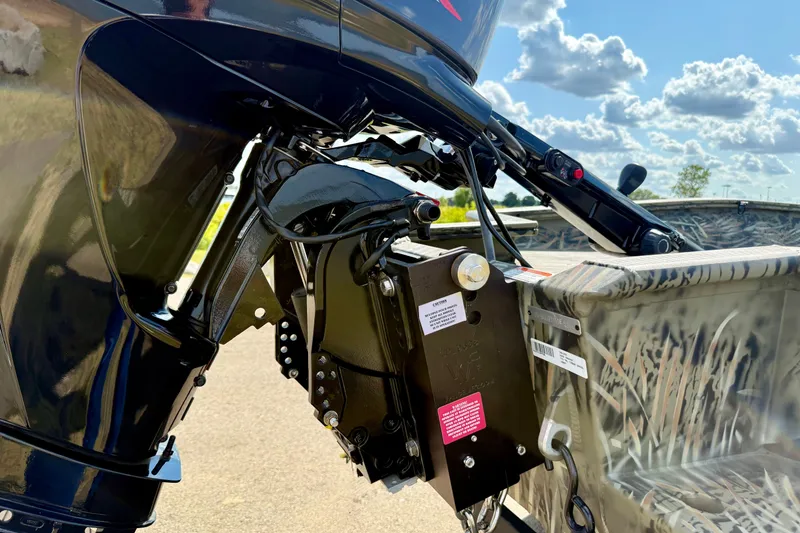 Slide: The Image of 2026 Tracker Grizzly 1650 T Prairie Wings Edition boat motor detail under a sunny sky. - 18