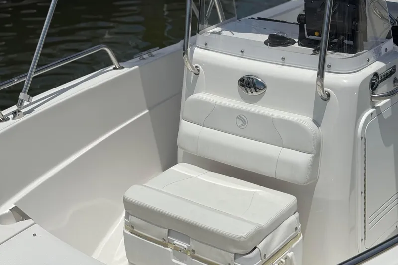 Slide: The Image of 2019 Edgewater 170CC boat interior with white seating and console. - 2