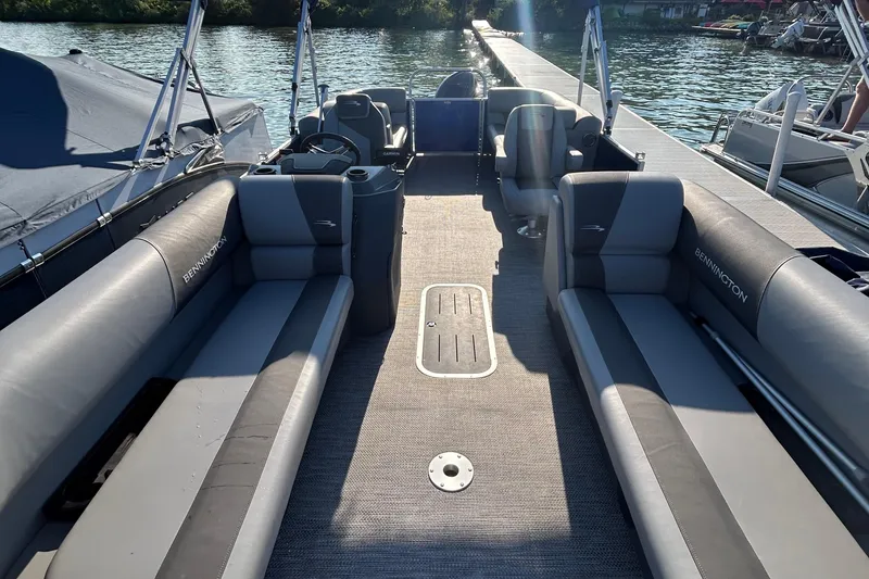 Slide: The Image of 2024 Bennington 22 SSR pontoon boat interior with gray seating and open deck space. - 2