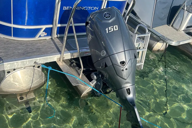Slide: The Image of 2024 Bennington 22 SSR pontoon boat with Yamaha 150 outboard motor in clear water. - 8