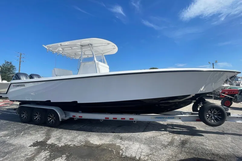 The Image of 2026 Contender 32 ST boat on trailer under clear blue sky. - 0