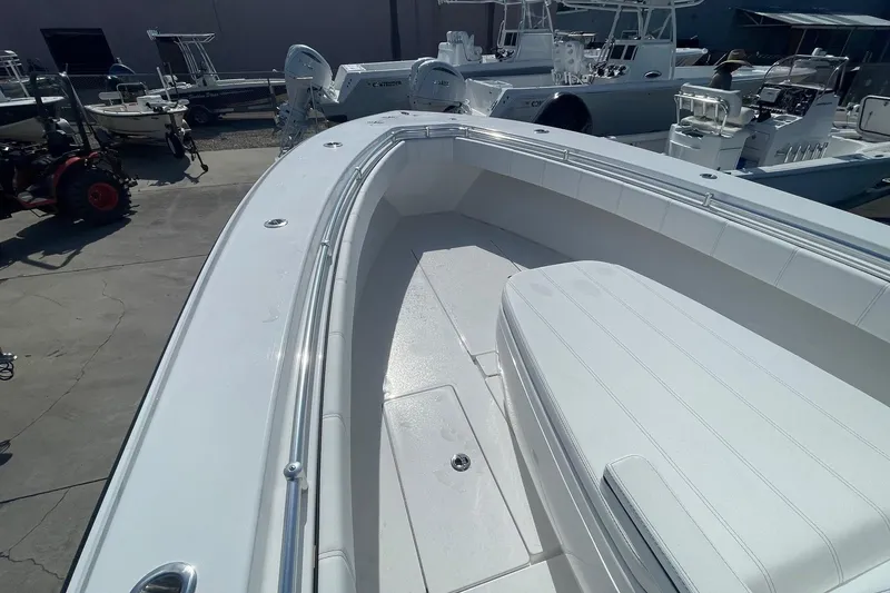 Slide: The Image of 2026 Contender 32 ST boat, sleek white deck, spacious seating, outdoor display. - 10