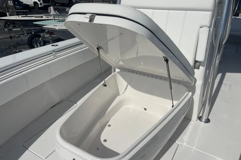 Slide: The Image of Open storage compartment on 2026 Contender 32 ST boat, showcasing spacious interior design. - 16