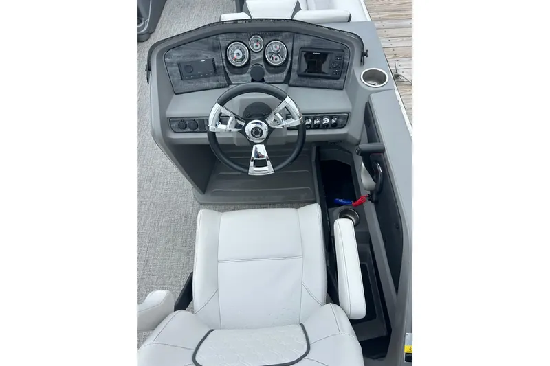 Slide: The Image of 2022 Avalon 22 LSZ Quad boat dashboard with steering wheel and controls. - 2