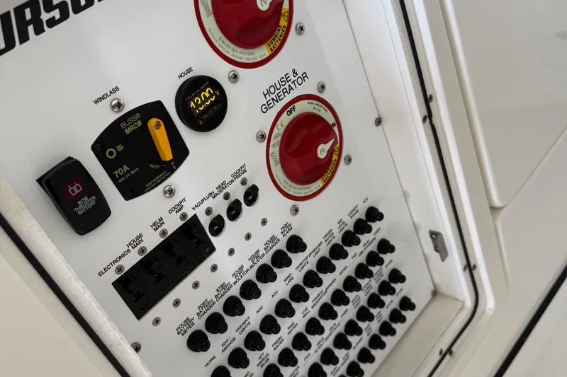 Slide: The Image of Control panel of 2022 Pursuit S 328 Sport boat with switches and gauges. - 10