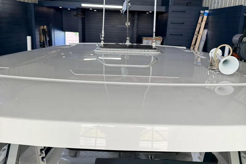 Slide: The Image of 2022 Pursuit S 328 Sport boat roof with mounted equipment in a garage setting. - 15