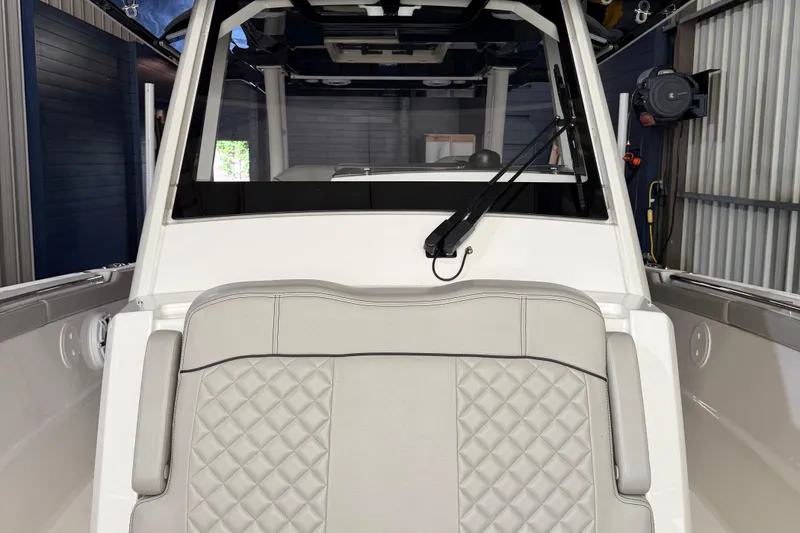 Slide: The Image of 2022 Pursuit S 328 Sport boat interior with quilted seating and windshield wiper. - 16