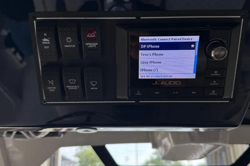 Slide: The Image of Control panel of a 2022 Pursuit S 328 Sport boat with Bluetooth device options. - 18