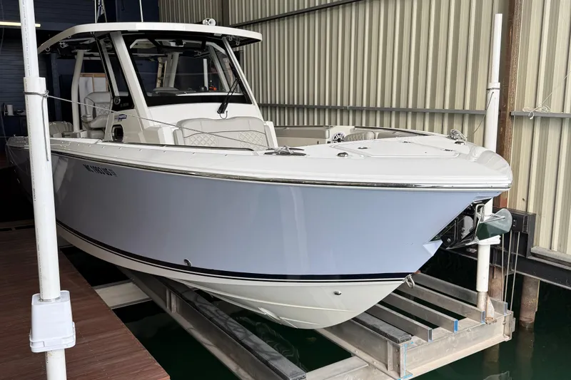 Slide: The Image of 2022 Pursuit S 328 Sport boat in storage, showcasing sleek design and modern features. - 2