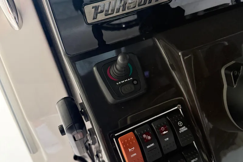 Slide: The Image of Control panel of 2022 Pursuit S 328 Sport boat with joystick and switches. - 21
