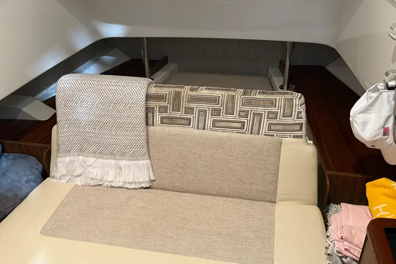 Slide: The Image of Interior of 2022 Pursuit S 328 Sport boat with cozy seating and decorative throw. - 22