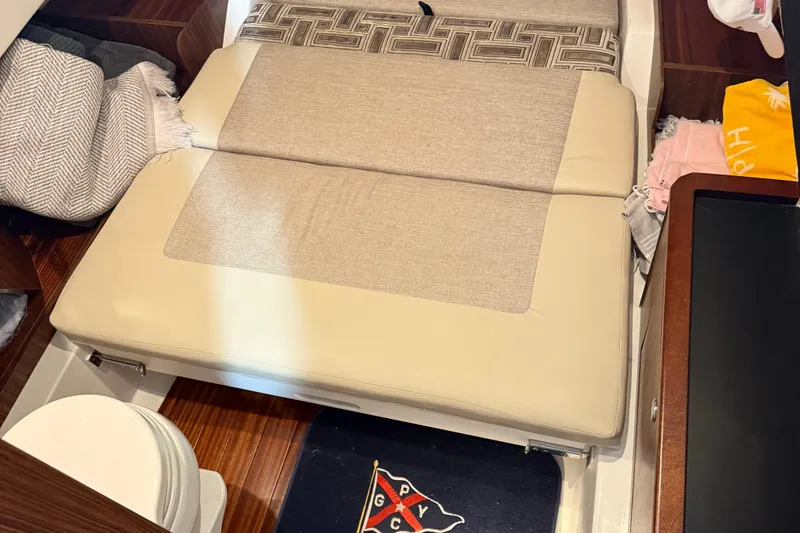 Slide: The Image of Interior cabin of 2022 Pursuit S 328 Sport boat with beige seating and nautical decor. - 23