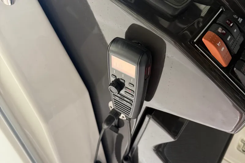 Slide: The Image of VHF radio on 2022 Pursuit S 328 Sport boat dashboard. - 24