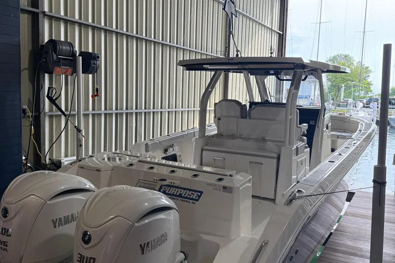 Slide: The Image of 2022 Pursuit S 328 Sport boat with Yamaha engines in a marina setting. - 3