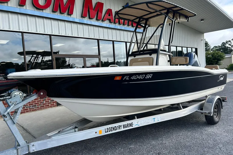 Slide: The Image of 2020 Scout 195 Sportfish boat on trailer outside marine dealership. - 2
