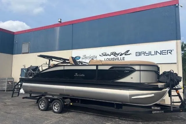 The Image of 2026 Barletta C22UC pontoon boat on trailer outside dealership. - 0