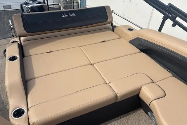 Slide: The Image of 2026 Barletta C22UC boat with tan cushioned seating and cup holders. - 10