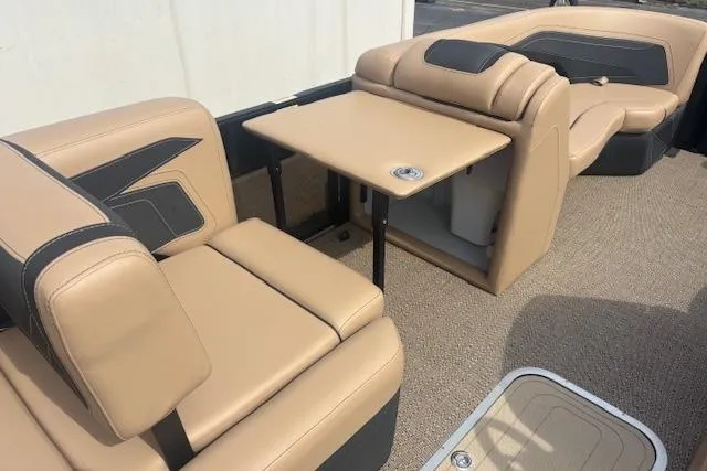 Slide: The Image of 2026 Barletta C22UC boat interior with beige seating and a foldable table. - 12