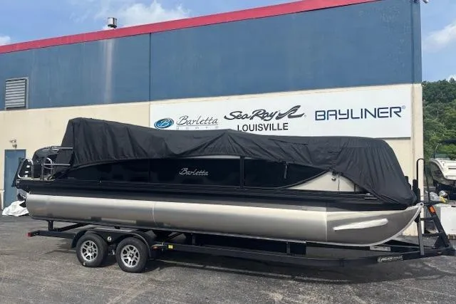 Slide: The Image of 2026 Barletta C22UC pontoon boat on trailer, covered, outside dealership. - 3