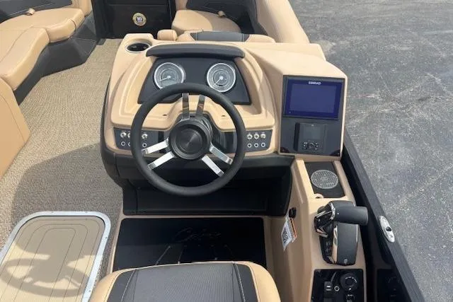 Slide: The Image of 2026 Barletta C22UC boat dashboard with steering wheel, gauges, and navigation screen. - 6