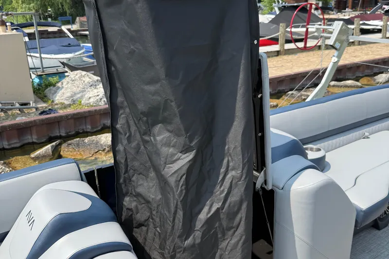 Slide: The Image of 2025 Avalon 25 LSZ Elite boat interior with seating and privacy curtain. - 2