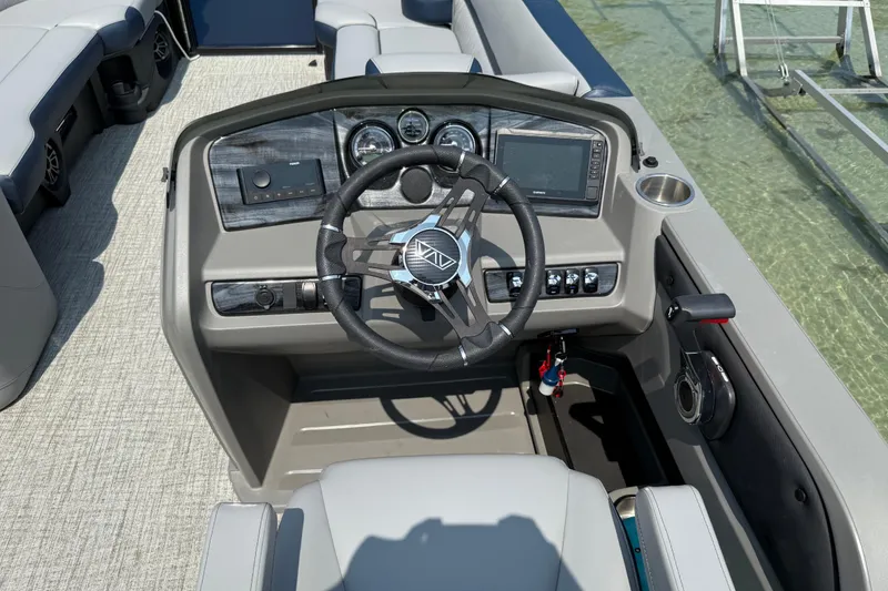 Slide: The Image of 2025 Avalon 25 LSZ ELITE boat dashboard with steering wheel and controls. - 5