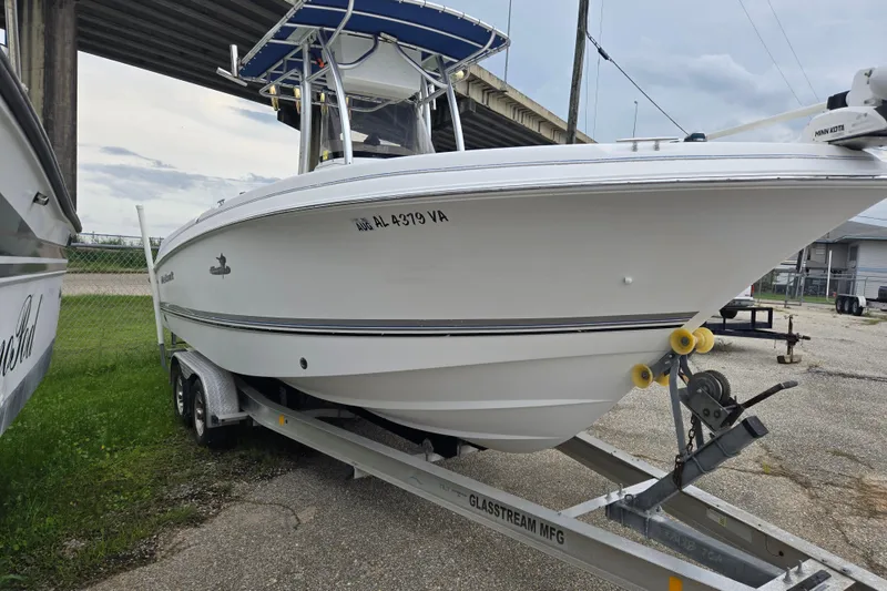 The Image of 2004 Wellcraft Tournament Edition boat on trailer, parked outdoors under a bridge. - 1