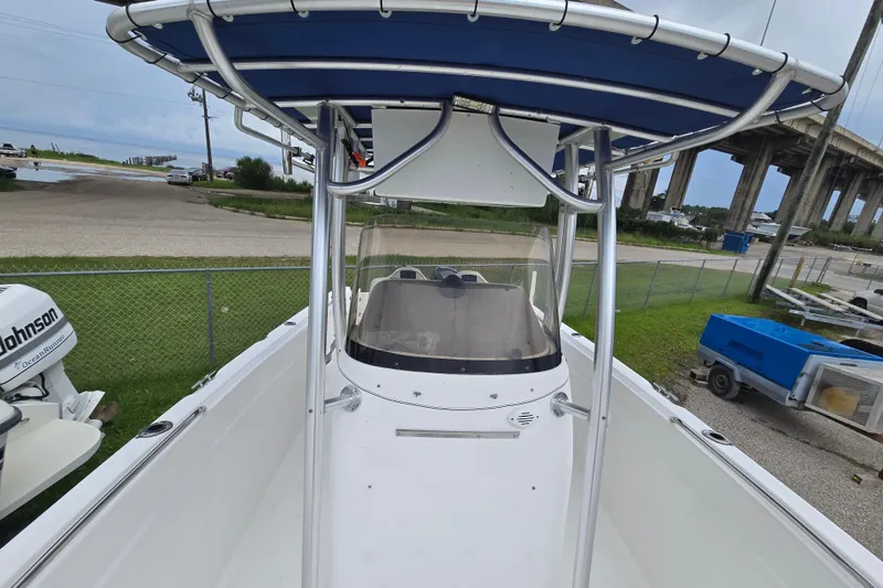 Slide: The Image of 2004 Wellcraft Tournament Edition boat with T-top and console, parked near a bridge. - 13