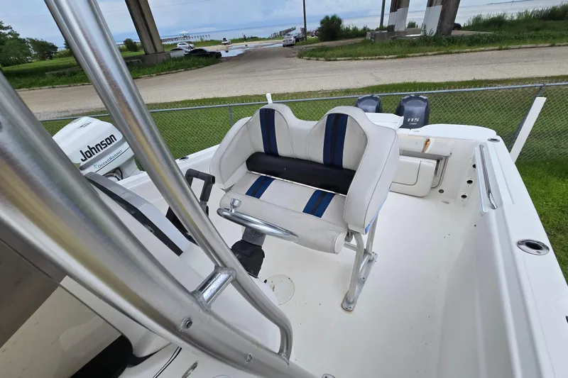 Slide: The Image of 2004 Wellcraft Tournament Edition boat with dual Johnson outboard motors, docked near a waterfront. - 14