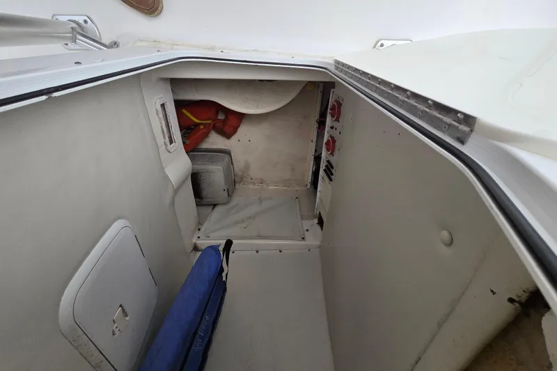 Slide: The Image of 2004 Wellcraft Tournament Edition boat storage compartment with life jackets and equipment. - 15