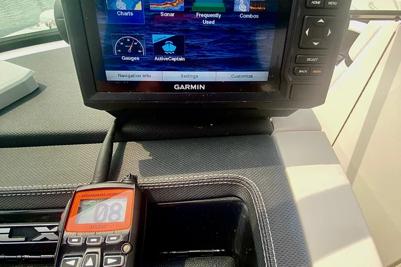 Slide: The Image of Garmin navigation system and radio on 2015 Sea Ray 250 SLX boat dashboard. - 11