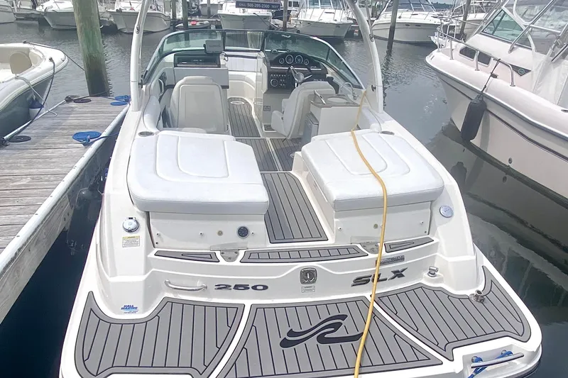 Slide: The Image of 2015 Sea Ray 250 SLX boat docked in marina, rear view. - 2