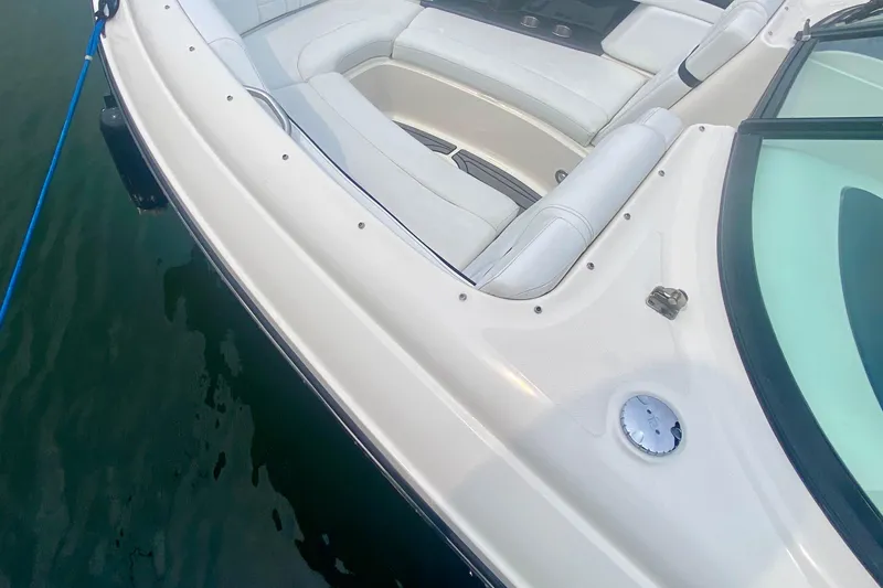 Slide: The Image of 2015 Sea Ray 250 SLX boat with white seating and sleek design on water. - 3