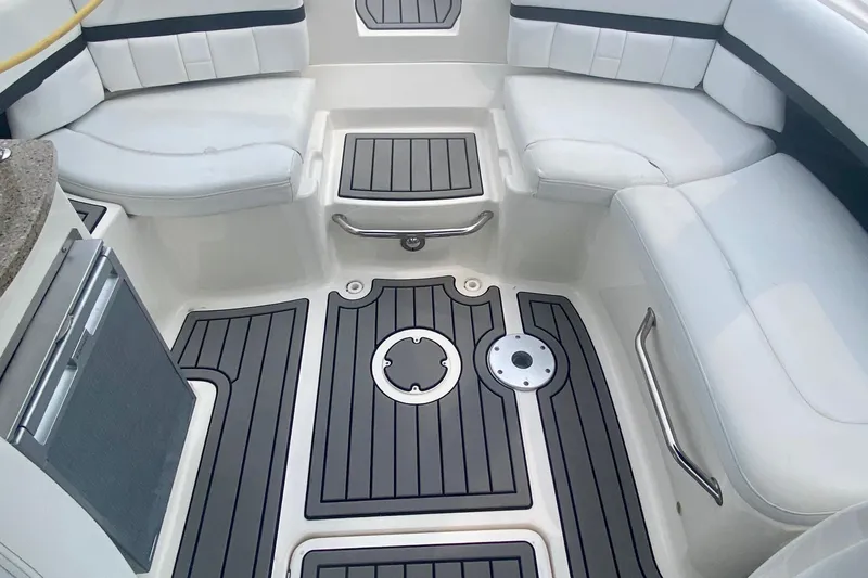 Slide: The Image of Interior of 2015 Sea Ray 250 SLX boat with cushioned seating and sleek flooring. - 4