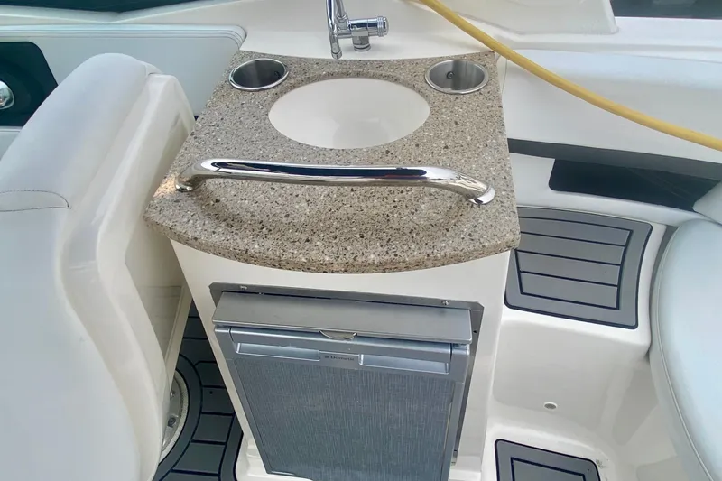 Slide: The Image of 2015 Sea Ray 250 SLX boat interior with sink and mini fridge. - 5