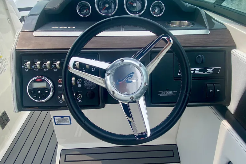 Slide: The Image of Steering wheel and dashboard of 2015 Sea Ray 250 SLX boat. - 7