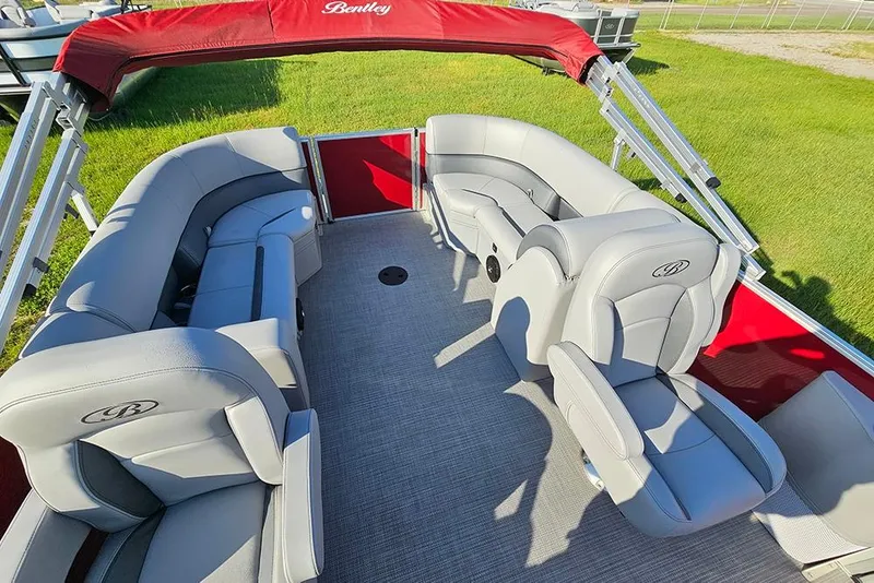 Slide: The Image of 2026 Bentley Pontoons 200 Fish CWT with red exterior and spacious seating on grass. - 13
