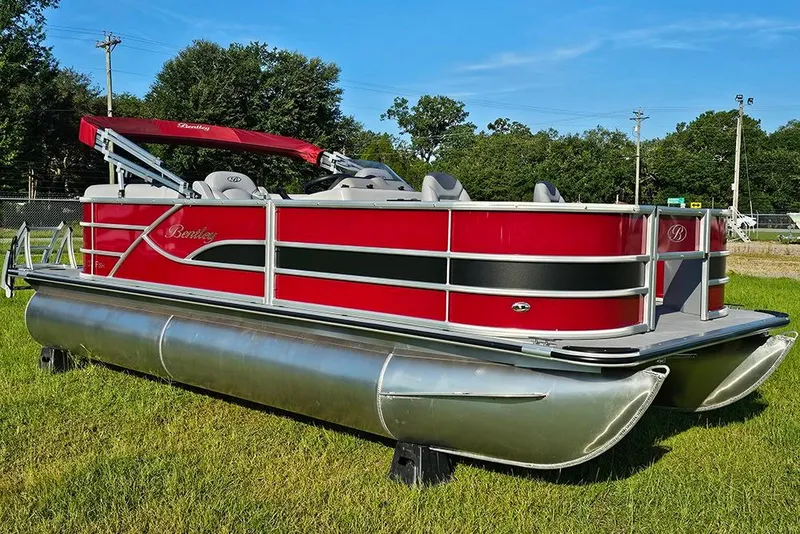 Slide: The Image of 2026 Bentley Pontoons 200 Fish CWT with Mercury outboard motor, parked outdoors. - 2