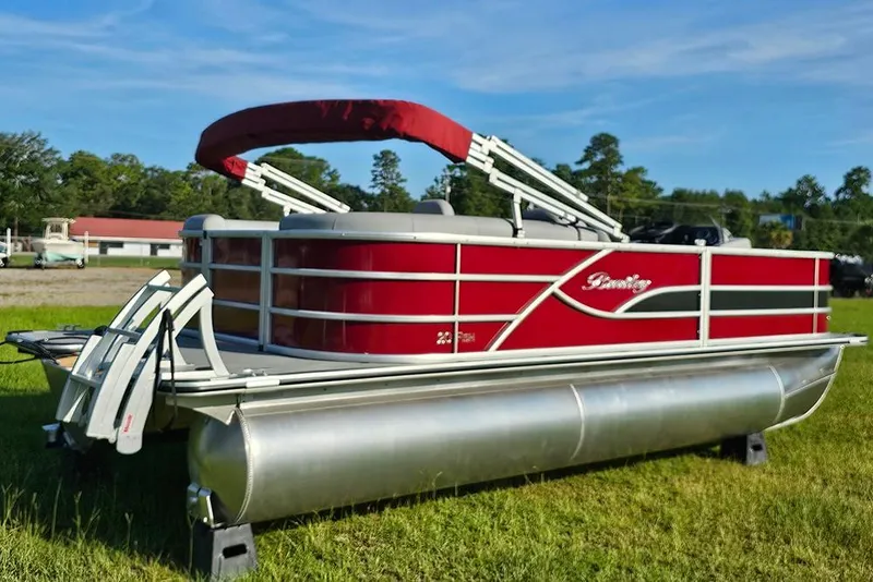 Slide: The Image of 2026 Bentley Pontoons 200 Fish CWT, red exterior, parked on grass under clear sky. - 3
