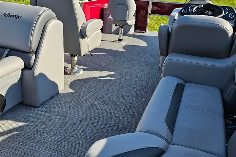 Slide: The Image of 2026 Bentley Pontoons 200 Fish CWT on grass, featuring maroon exterior and sleek design. - 9