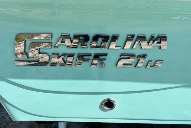 Slide: The Image of 2026 Carolina Skiff 21 LS boat logo on light blue hull. - 10