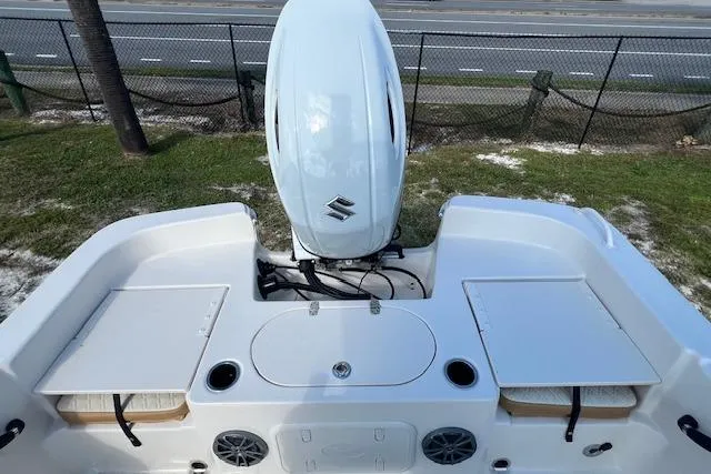 Slide: The Image of 2026 Carolina Skiff 21 LS boat with Suzuki outboard motor, rear deck view. - 2