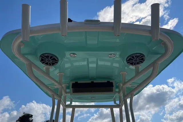 Slide: The Image of 2026 Carolina Skiff 21 LS boat top view with speakers against blue sky. - 4