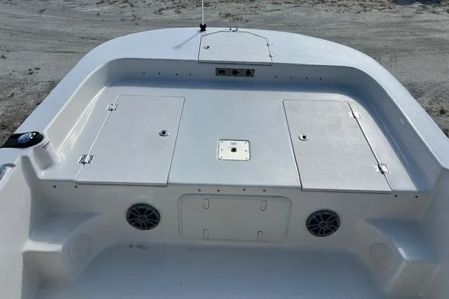 Slide: The Image of 2026 Carolina Skiff 21 LS boat deck with storage compartments and speakers. - 8