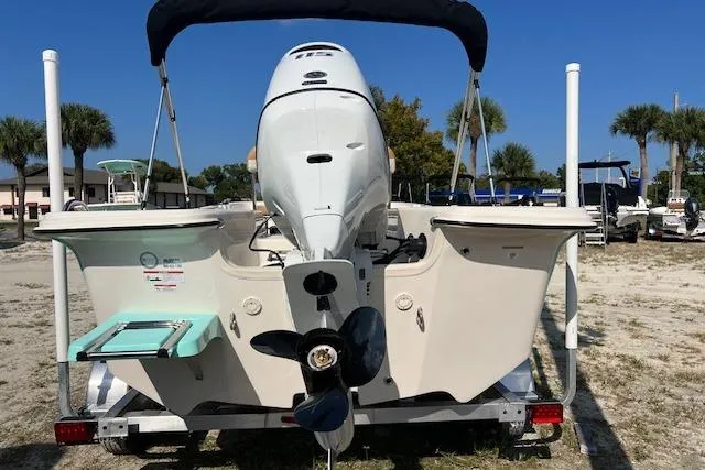 Slide: The Image of 2026 Carolina Skiff 17 LS boat, rear view with outboard motor, on trailer, sunny day. - 2