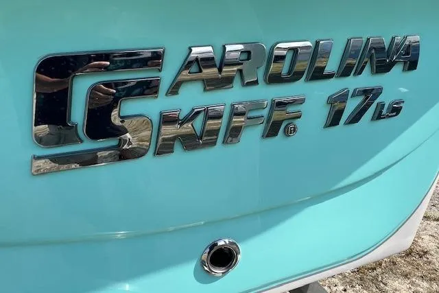 Slide: The Image of 2026 Carolina Skiff 17 LS logo on light blue boat exterior. - 8