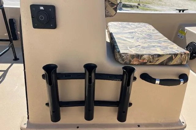Slide: The Image of Carolina Skiff E18 JVX CC 2026 boat interior with rod holders and camo seat cushion. - 6