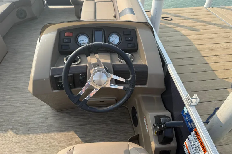 Slide: The Image of 2023 Bennington 24 SSR boat dashboard with steering wheel and gauges. - 5