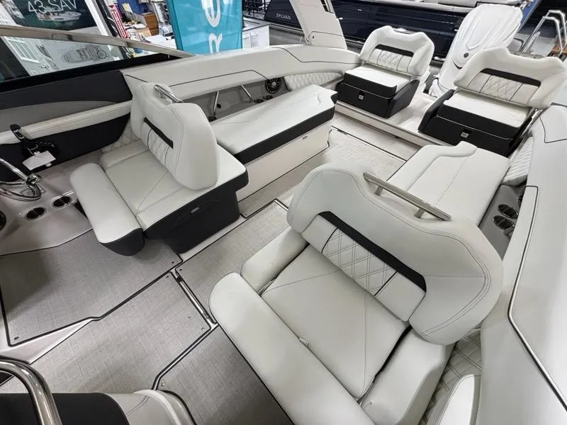 Slide: The Image of 2026 Regal LX6 boat interior with luxurious white seating and modern design. - 24