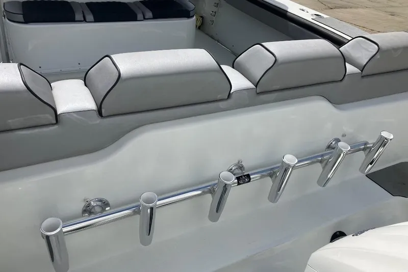 Slide: The Image of 2012 Yellowfin 42 Offshore boat interior with rod holders and cushioned seating. - 12